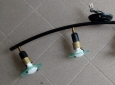 Lampada da soffitto con base curva nera e quattro punti luce.